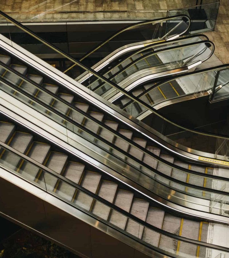 From above shot of moving staircases inside modern building in Miami